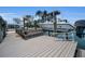 Dock with boat lift, bench, and space to relax, offering a serene waterfront experience at 4381 Poinsettia Dr, St Pete Beach, FL 33706