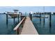 Waterfront dock with boat lift offers direct access to the open water and a peaceful coastal lifestyle at 4381 Poinsettia Dr, St Pete Beach, FL 33706