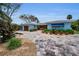 Charming home showcasing a meticulously landscaped front yard and a brick driveway at 4381 Poinsettia Dr, St Pete Beach, FL 33706