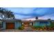 Beautiful single-story house featuring a custom wood entry and meticulously landscaped front yard at 4381 Poinsettia Dr, St Pete Beach, FL 33706