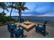 Outdoor stone fire pit with Adirondack chairs, perfect for enjoying waterfront views at 4381 Poinsettia Dr, St Pete Beach, FL 33706