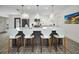 Open kitchen with a large island, modern appliances, and a breakfast bar with comfortable seating at 4381 Poinsettia Dr, St Pete Beach, FL 33706
