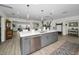 Open-concept kitchen with stainless steel appliances, a large island, and an adjacent living space at 4381 Poinsettia Dr, St Pete Beach, FL 33706