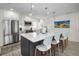Spacious kitchen featuring stainless steel appliances, white countertops, and a large center island with seating at 4381 Poinsettia Dr, St Pete Beach, FL 33706