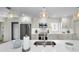 Bright kitchen with stainless steel appliances, white cabinets, and a center island with bar seating at 4381 Poinsettia Dr, St Pete Beach, FL 33706