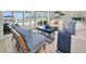 Bright living room with stylish blue accents, modern furniture, and sliding glass doors to the waterfront patio at 4381 Poinsettia Dr, St Pete Beach, FL 33706