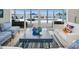 Open living space with a view to the waterfront patio and pool through large glass doors at 4381 Poinsettia Dr, St Pete Beach, FL 33706