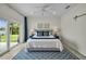 Serene main bedroom featuring a blue accent rug, slider to patio, and waterfront views at 4381 Poinsettia Dr, St Pete Beach, FL 33706