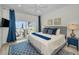Relaxing main bedroom with waterfront views, blue accents, and a private patio access at 4381 Poinsettia Dr, St Pete Beach, FL 33706