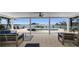 Waterfront patio featuring outdoor seating, a pool, and picturesque views of the bay at 4381 Poinsettia Dr, St Pete Beach, FL 33706