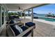 Serene patio space featuring outdoor furniture, landscaping and water views at 4381 Poinsettia Dr, St Pete Beach, FL 33706