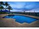 Stunning twilight view of the pool, spa, and boat dock at 4381 Poinsettia Dr, St Pete Beach, FL 33706