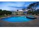 Backyard featuring a swimming pool, hot tub, lounge chairs, and covered patio with dining area at 4381 Poinsettia Dr, St Pete Beach, FL 33706