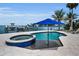 Sparkling pool and spa area with dock and boat lift access on the water at 4381 Poinsettia Dr, St Pete Beach, FL 33706