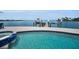 Inviting pool and dock area with boat lift providing waterfront living at 4381 Poinsettia Dr, St Pete Beach, FL 33706