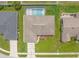 Overhead shot of home with pool, manicured lawn, and neutral roof at 4530 Zack Dr, New Port Richey, FL 34653