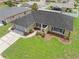Aerial view of the home showcasing its manicured lawn, screened garage, and charming curb appeal at 4530 Zack Dr, New Port Richey, FL 34653