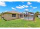 Home exterior featuring a green lawn and screened-in pool at 4530 Zack Dr, New Port Richey, FL 34653
