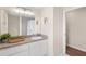 Bathroom with white cabinets, a large mirror, and a shower, providing a clean and functional space at 4530 Zack Dr, New Port Richey, FL 34653