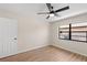 Comfortable bedroom featuring wood floors, a ceiling fan, and a window offering natural light at 4530 Zack Dr, New Port Richey, FL 34653