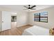 Bright bedroom with wood flooring, ceiling fan, and a large window offering great natural light at 4530 Zack Dr, New Port Richey, FL 34653