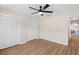 Spacious bedroom with wood floors, ceiling fan, and ample closet space, providing comfort and storage at 4530 Zack Dr, New Port Richey, FL 34653