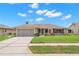 Charming single-story home with a two-car garage and a well-maintained front yard at 4530 Zack Dr, New Port Richey, FL 34653