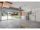 Spacious garage with an open door, ladders, and a concrete floor at 4530 Zack Dr, New Port Richey, FL 34653