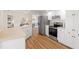 Modern kitchen with stainless steel appliances, white cabinetry, and an open layout at 4530 Zack Dr, New Port Richey, FL 34653