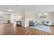Open concept living room with wood floors, wainscoting, and neutral paint colors at 4530 Zack Dr, New Port Richey, FL 34653