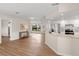 Open-concept living space featuring wood flooring, a breakfast bar, and modern lighting at 4530 Zack Dr, New Port Richey, FL 34653