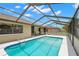 Relaxing screened-in pool area with clear blue water and access to the home at 4530 Zack Dr, New Port Richey, FL 34653