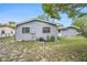 Back exterior of the house with siding, AC unit, and two back doors at 4570 Essex Ln, Spring Hill, FL 34606