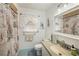 Nautical themed bathroom with patterned shower curtain, unique tile flooring, and vanity with sink at 4570 Essex Ln, Spring Hill, FL 34606