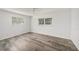 Inviting bedroom with wood-look flooring, two windows and a ceiling fan at 4570 Essex Ln, Spring Hill, FL 34606
