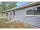 Side view of the house showing the siding, windows, and side entry door at 4570 Essex Ln, Spring Hill, FL 34606