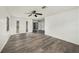 A bright living room with new wood flooring, white walls, and a modern ceiling fan at 4570 Essex Ln, Spring Hill, FL 34606