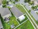 Aerial view shows fenced backyard with a covered patio at 4902 Grist Mill Ct, Wimauma, FL 33598