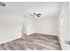 Bright bedroom with fan, neutral paint, and wood-look flooring offering a modern aesthetic at 4902 Grist Mill Ct, Wimauma, FL 33598