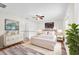 Serene bedroom featuring a plush bed, decorative dresser, and ample natural light from large window at 4902 Grist Mill Ct, Wimauma, FL 33598
