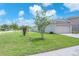 Well-maintained home with green lawn and attached two-car garage at 4902 Grist Mill Ct, Wimauma, FL 33598