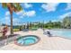 Relaxing hot tub provides a luxurious spa-like experience with seating and covered area at 4902 Grist Mill Ct, Wimauma, FL 33598