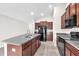 A kitchen showcases granite counters, stainless steel appliances, and stylish brown cabinetry at 4902 Grist Mill Ct, Wimauma, FL 33598
