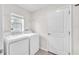Practical laundry room with washer, dryer, shelving, and a window at 4902 Grist Mill Ct, Wimauma, FL 33598