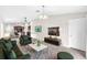Comfortable living area with plush seating, a large TV, and an open view to the modern kitchen at 4902 Grist Mill Ct, Wimauma, FL 33598