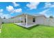 Outdoor covered patio with concrete flooring and green backyard at 4902 Grist Mill Ct, Wimauma, FL 33598