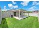 Outdoor covered patio with concrete flooring and green backyard at 4902 Grist Mill Ct, Wimauma, FL 33598