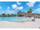 Community pool with zero entry, lounge seating, and lush landscaping offers luxurious relaxation at 4902 Grist Mill Ct, Wimauma, FL 33598