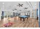 Spacious recreation room is perfect for fun with billiards and plenty of seating for gathering at 4902 Grist Mill Ct, Wimauma, FL 33598