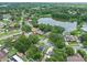Community aerial showcases homes near a pond, surrounded by mature trees and landscaping at 4906 Presidential St, Seffner, FL 33584